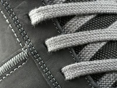 Close up of gym shoes on a grey background.
