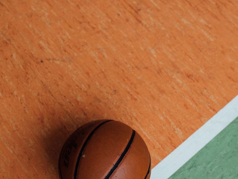 Close up of sports equipment on a clean white floor.